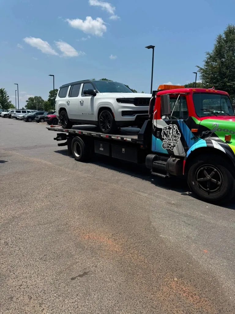 Nelms Towing LLC rollback towing private Jeep SUV in Charlotte NC