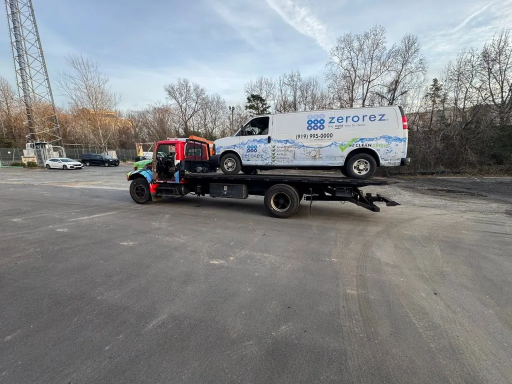 Nelms Towing LLC flatbed transporting Zerorez commercial cleaning van in Charlotte NC